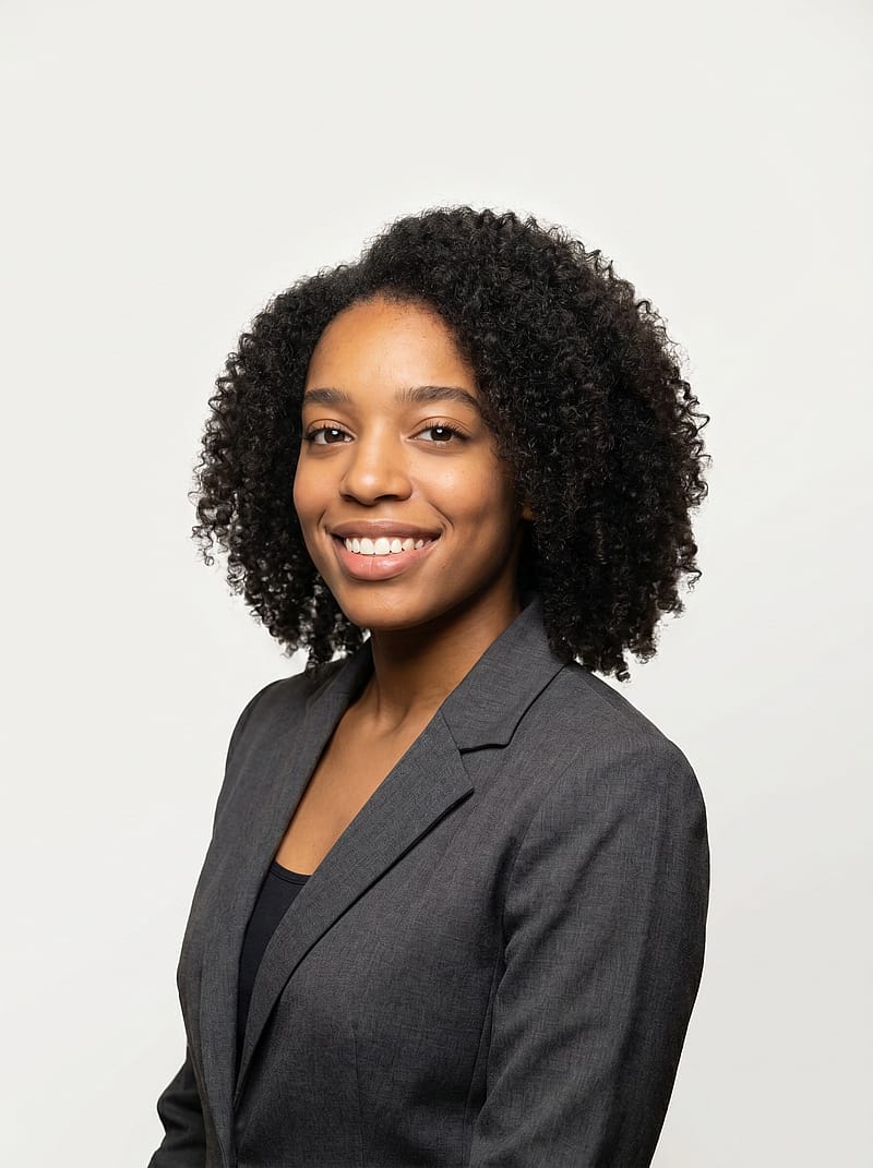 Refined professional portrait with structured blazer, soft studio lighting, poised expression for business profiles.