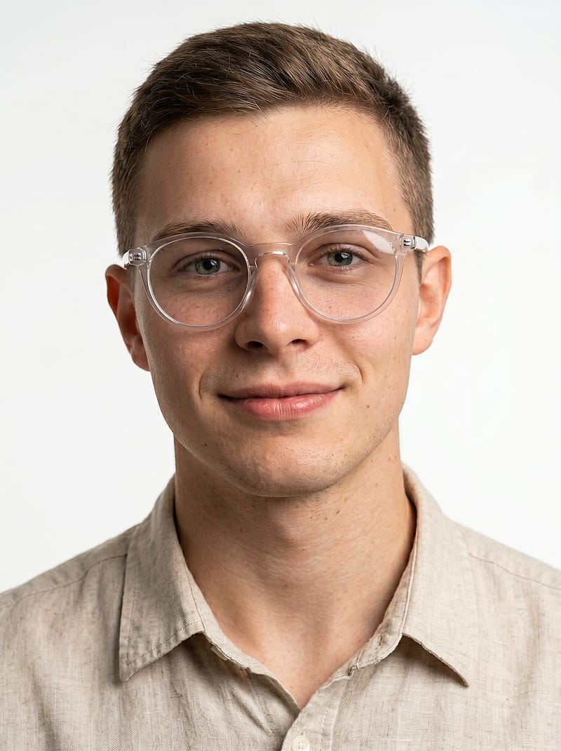 Clean studio portrait in linen shirt and round sunglasses against matte white background with hyper-realistic skin detail.